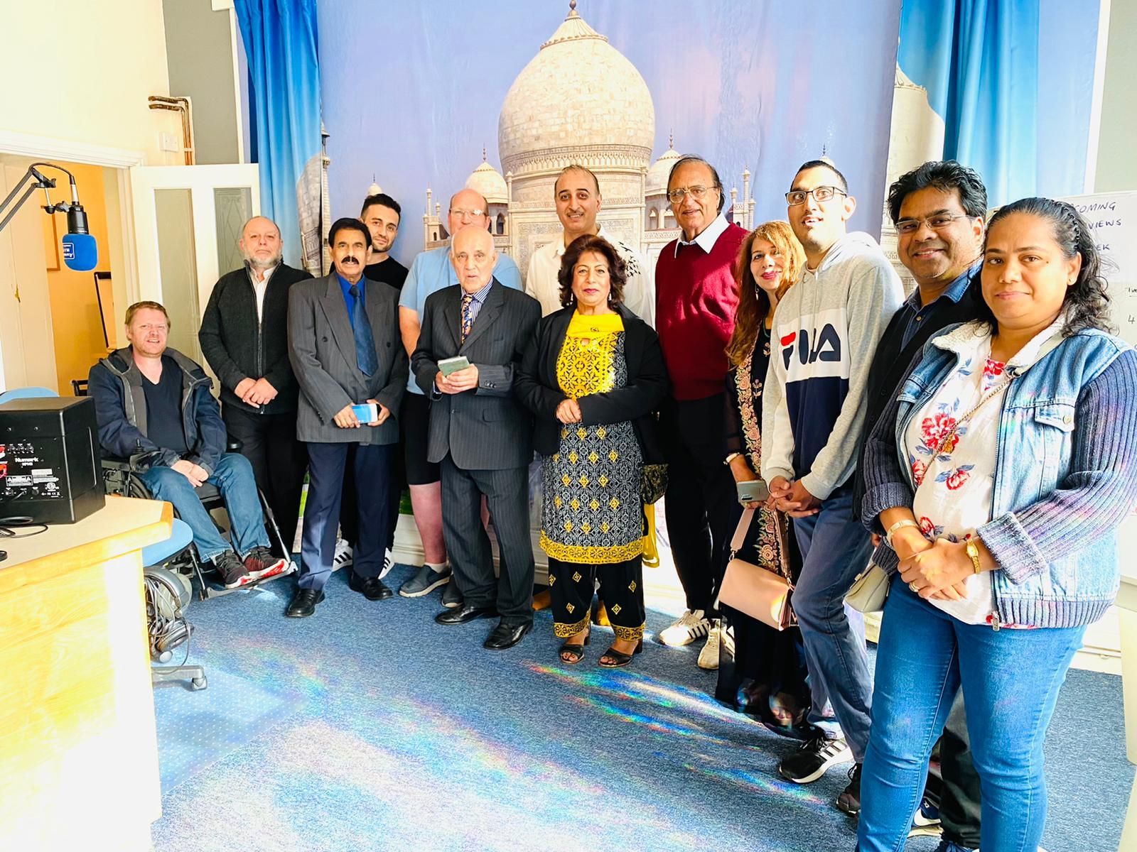 A group of people are posing for a picture in front of a building.