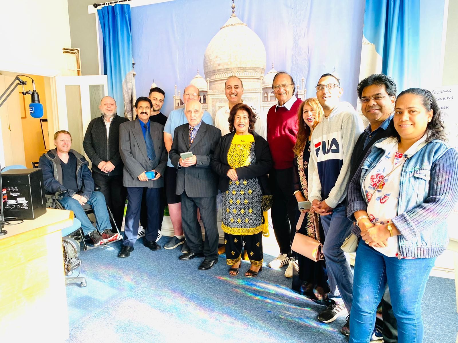 A group of people are posing for a picture in a room.