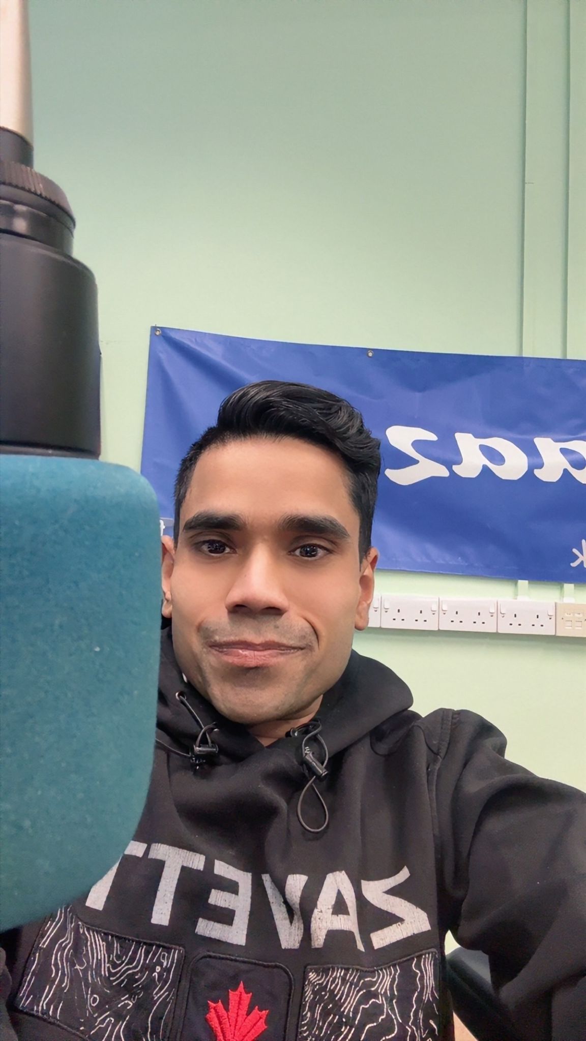 A man in a camouflage jacket is sitting in a chair.