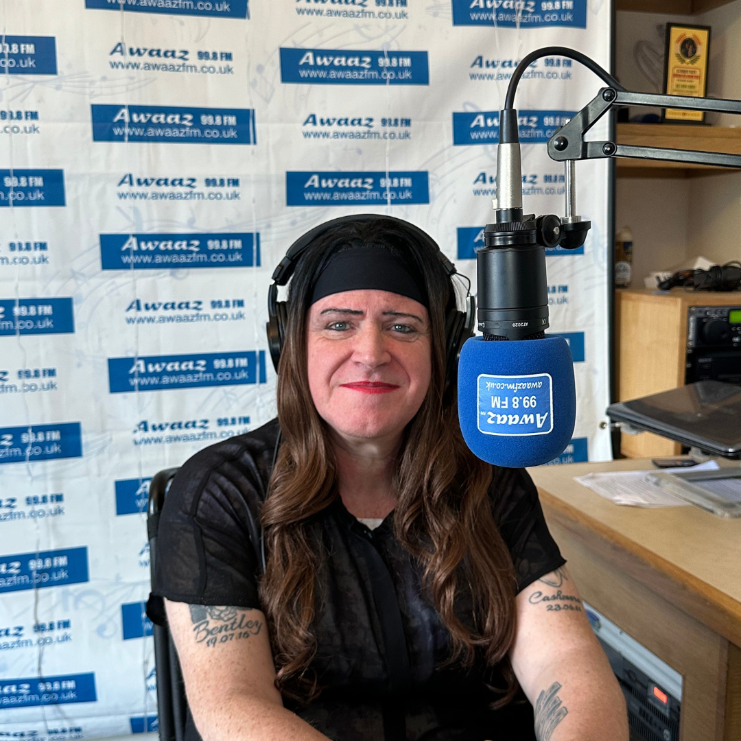 A man wearing headphones and a blue microphone with the word awarz on it