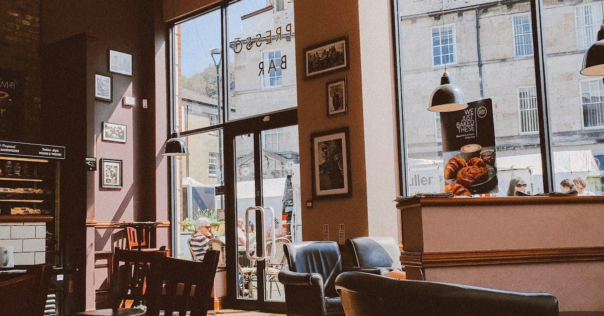 A restaurant with a lot of windows and tables and chairs.