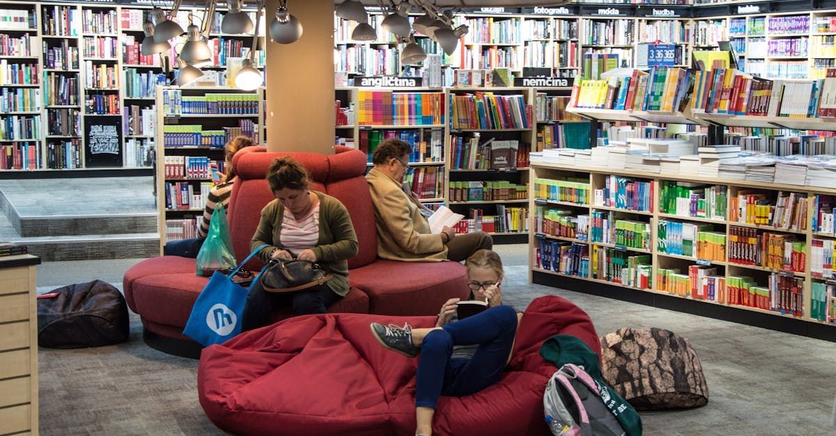A group of people are sitting on bean bags in a bookstore.