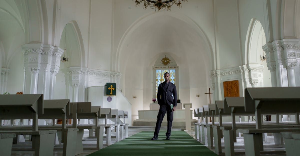 A man is standing in the middle of a church.