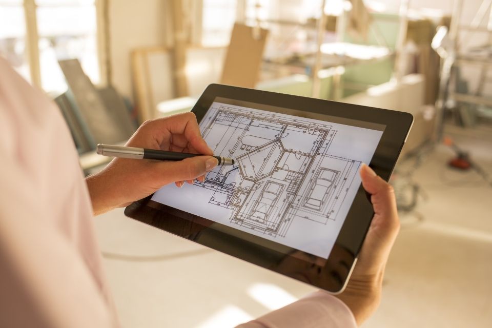architect woman working with a stylus on and electronic tablet.