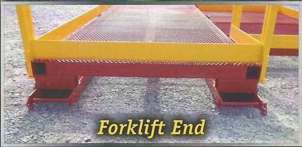 Forklift end of a yellow and red metal platform with the words 