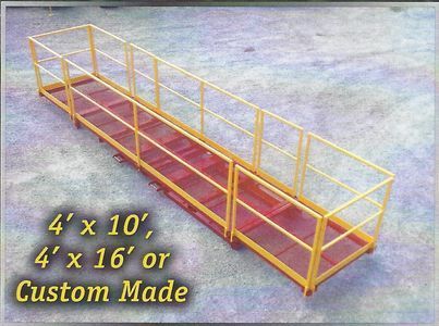 Yellow metal safety platform with handrails. Options: 4'x10', 4'x16', or custom made. On a concrete surface.