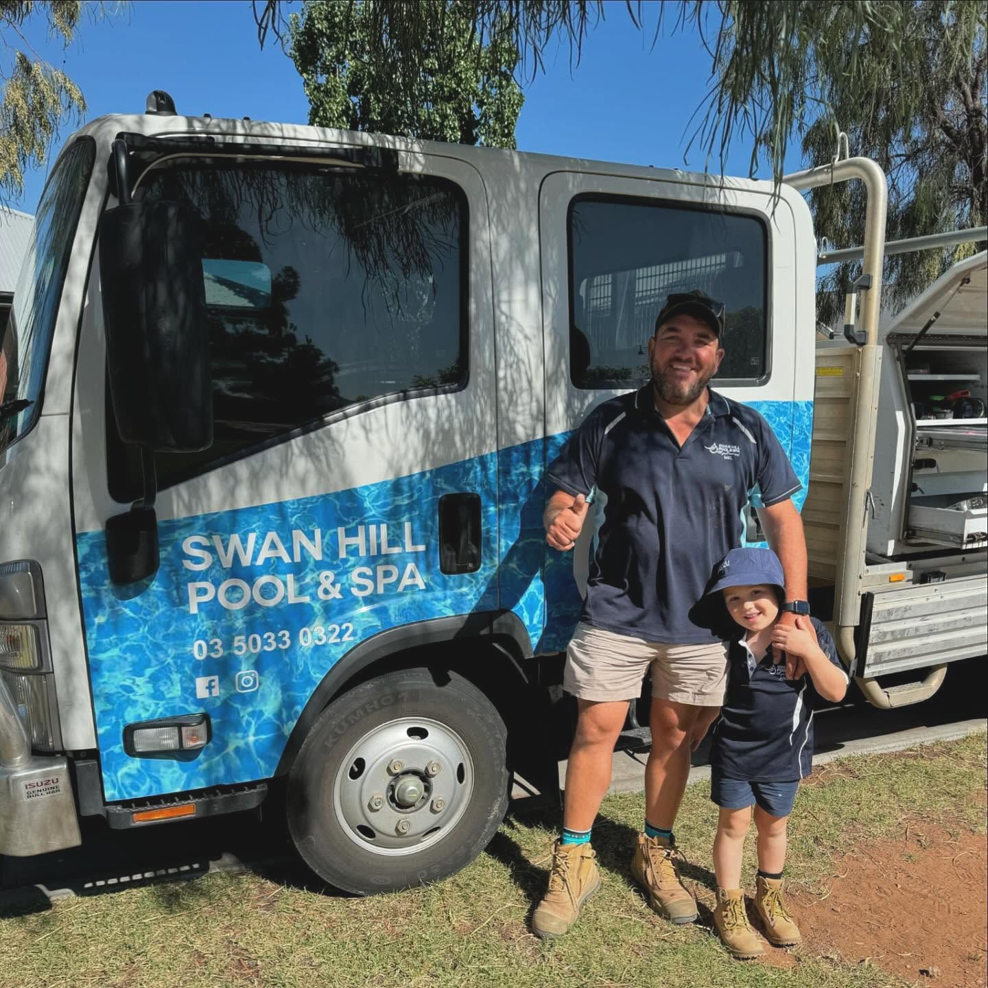 Man and Young Boy in Front of A Truck— Swan Hill Pool & Spa Centre in Swan Hill, VIC