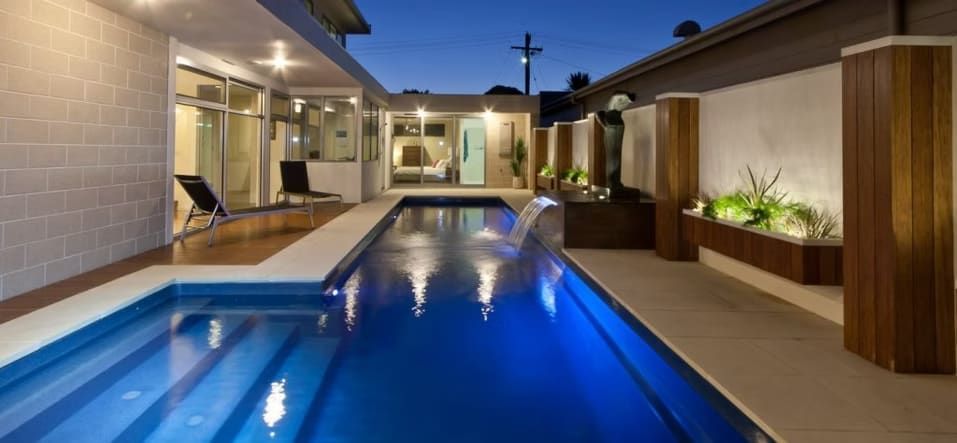 A Rectangular Pool at Dusk with Water Feature — Swan Hill Pool & Spa Centre in Swan Hill, VIC