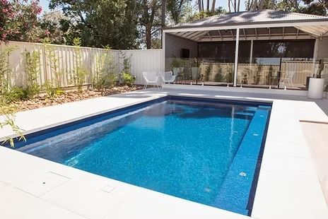 Rectangular Blue-Tiled Pool Surrounded by White Concrete — Swan Hill Pool & Spa Centre in Swan Hill, VIC