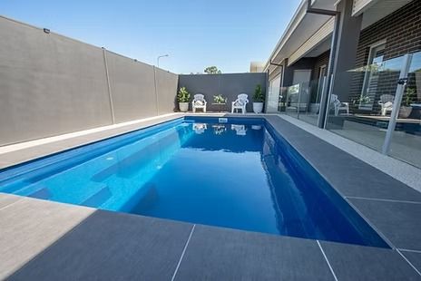 Rectangular Blue Swimming Pool Beside a Modern Home — Swan Hill Pool & Spa Centre in Swan Hill, VIC
