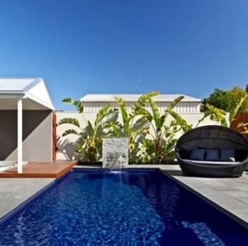 Swimming Pool in A Backyard with Lounge Seating — Swan Hill Pool & Spa Centre in Swan Hill, VIC