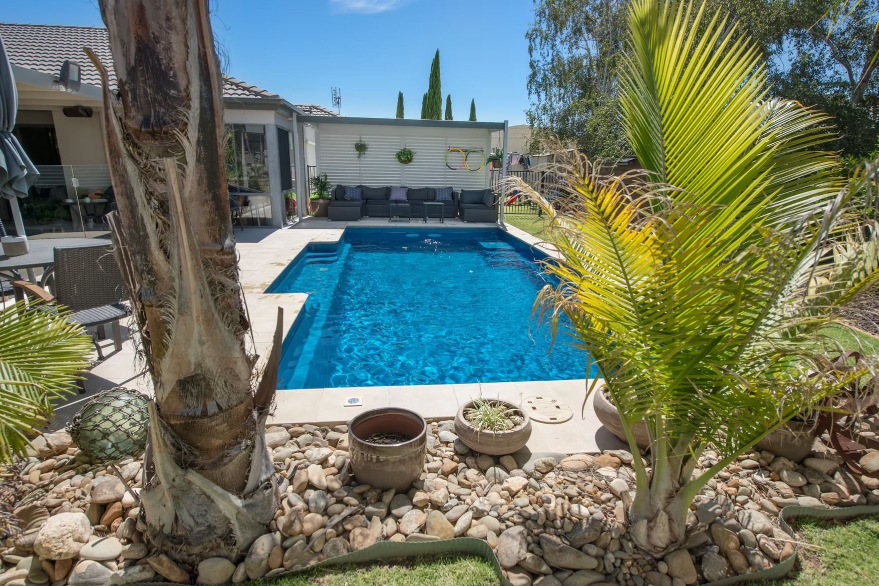 Swimming Pool in A Backyard with Blue Water — Swan Hill Pool & Spa Centre in Swan Hill, VIC