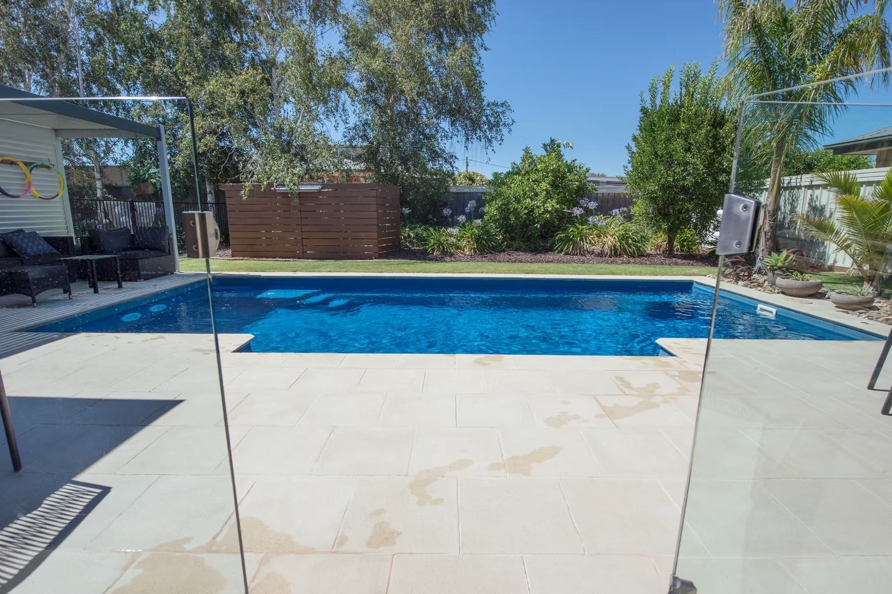 A Rectangular Blue Swimming Pool Surrounded by Tiles — Swan Hill Pool & Spa Centre in Swan Hill, VIC