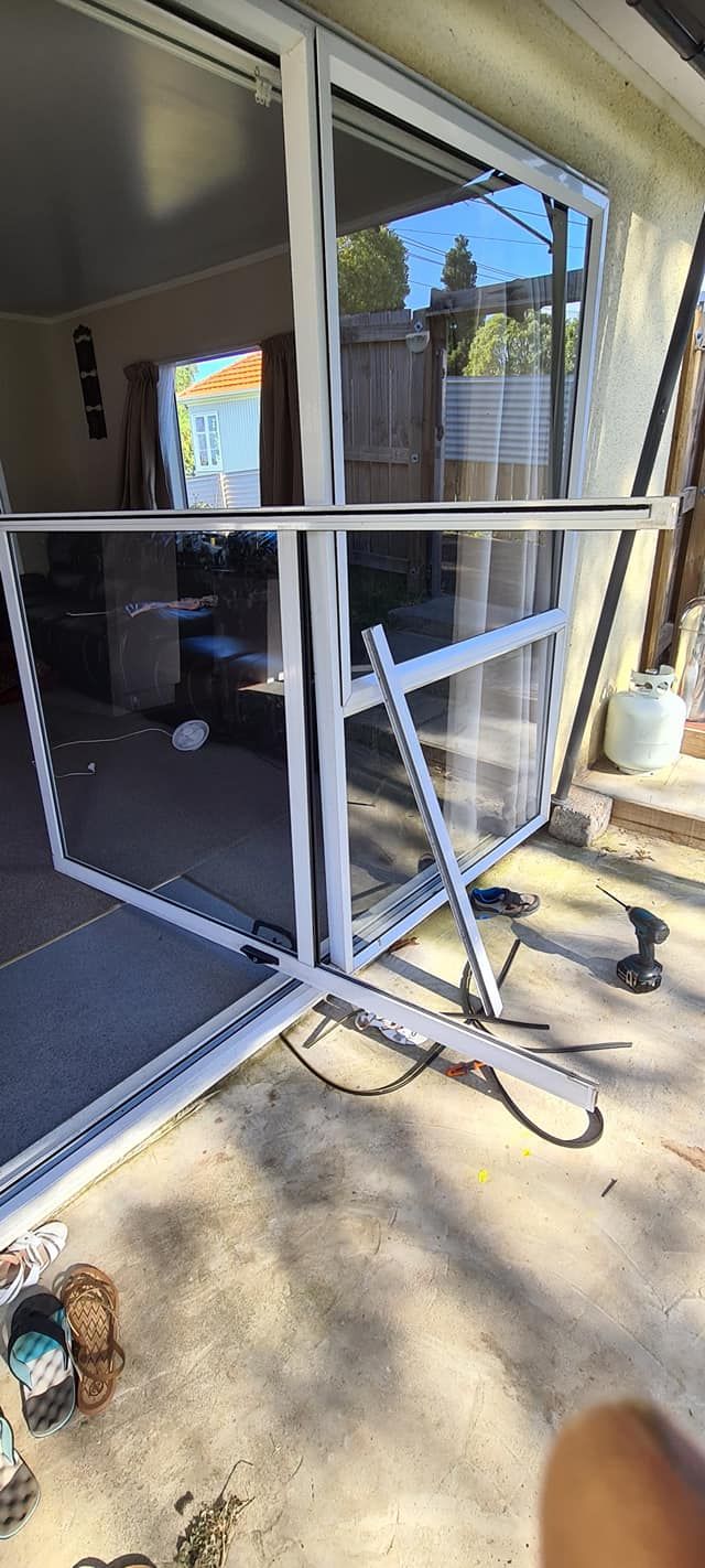 A sliding glass door is being installed in a house.