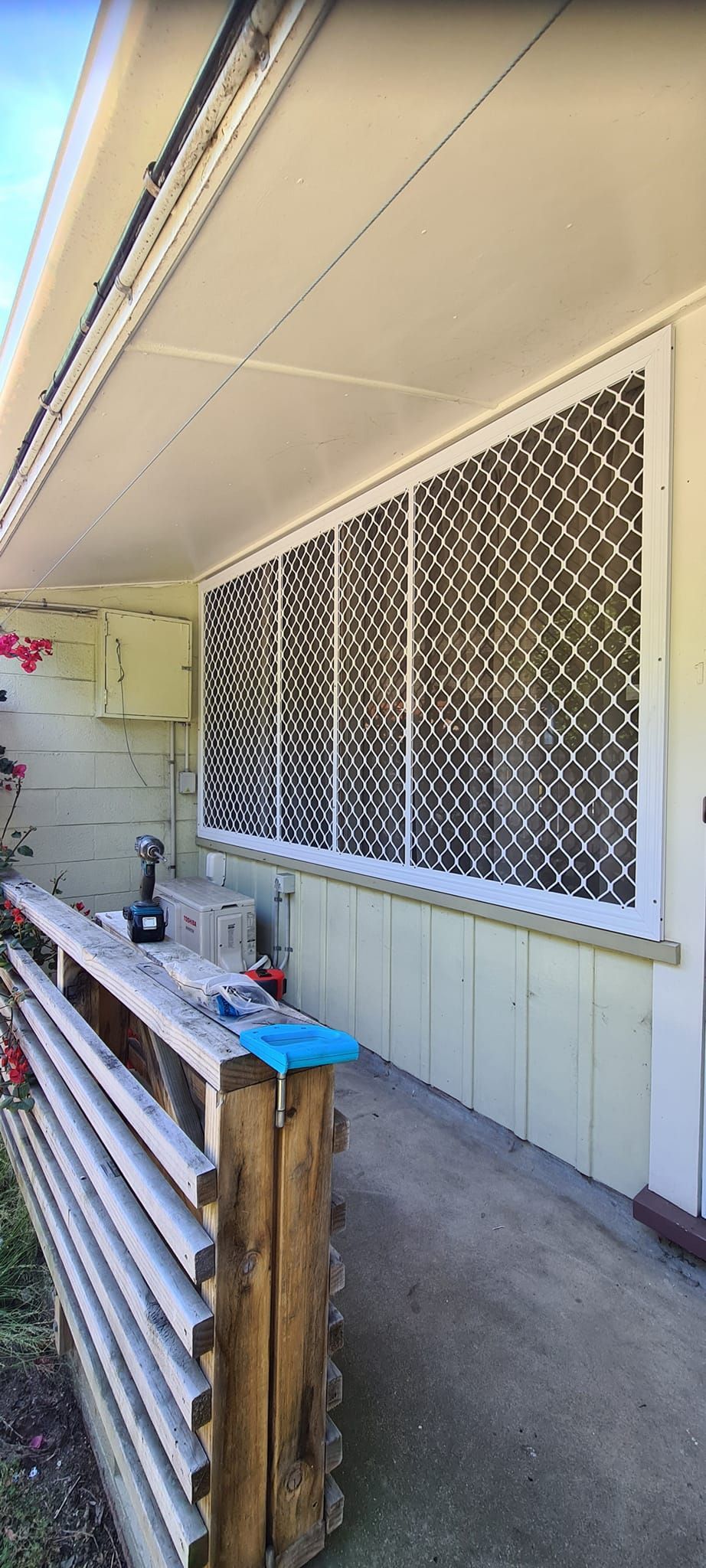 A house with a fence and a window with a pattern on it.