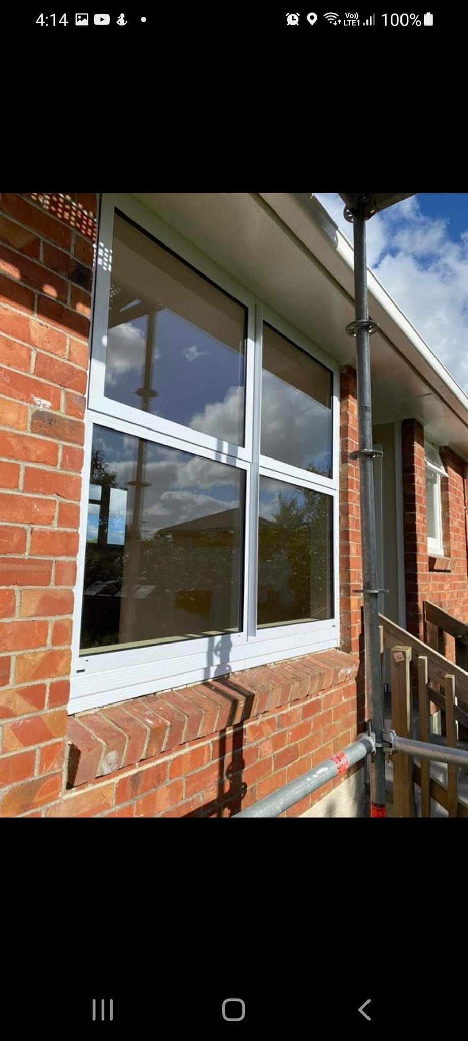 A brick building with a large window on the side of it.