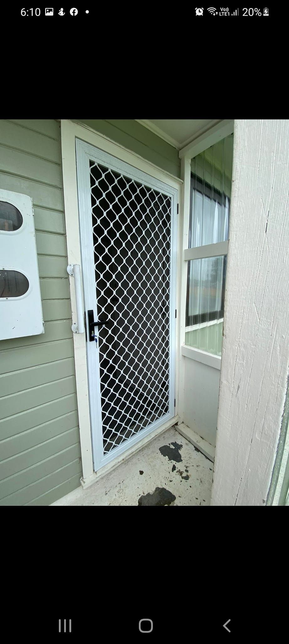 A picture of a door with a screen on it.