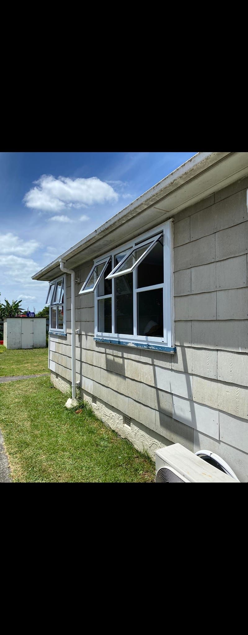 A house with a lot of windows on the side of it.
