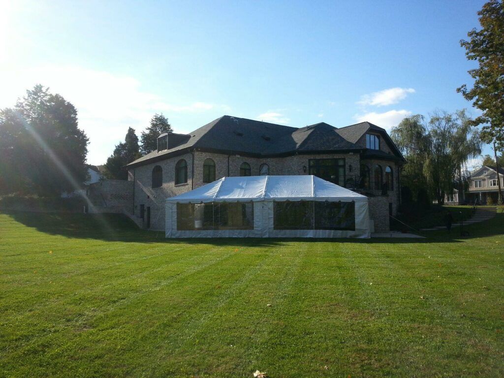 A large house with a white tent in front of it