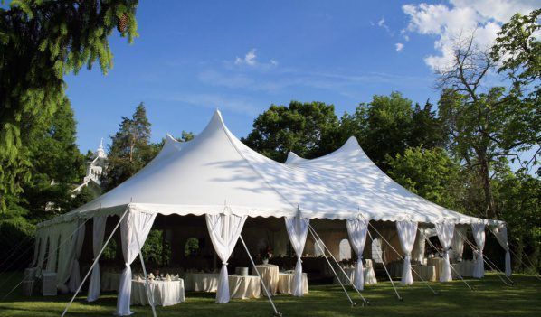 A Large White Tent in the Middle of a Grassy Field