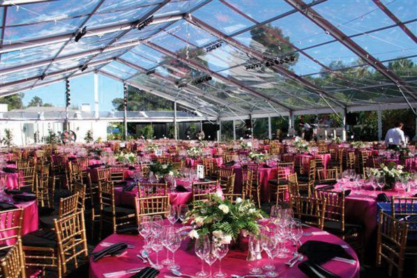 Tables and Chairs Are Set Up Under a Clear Tent