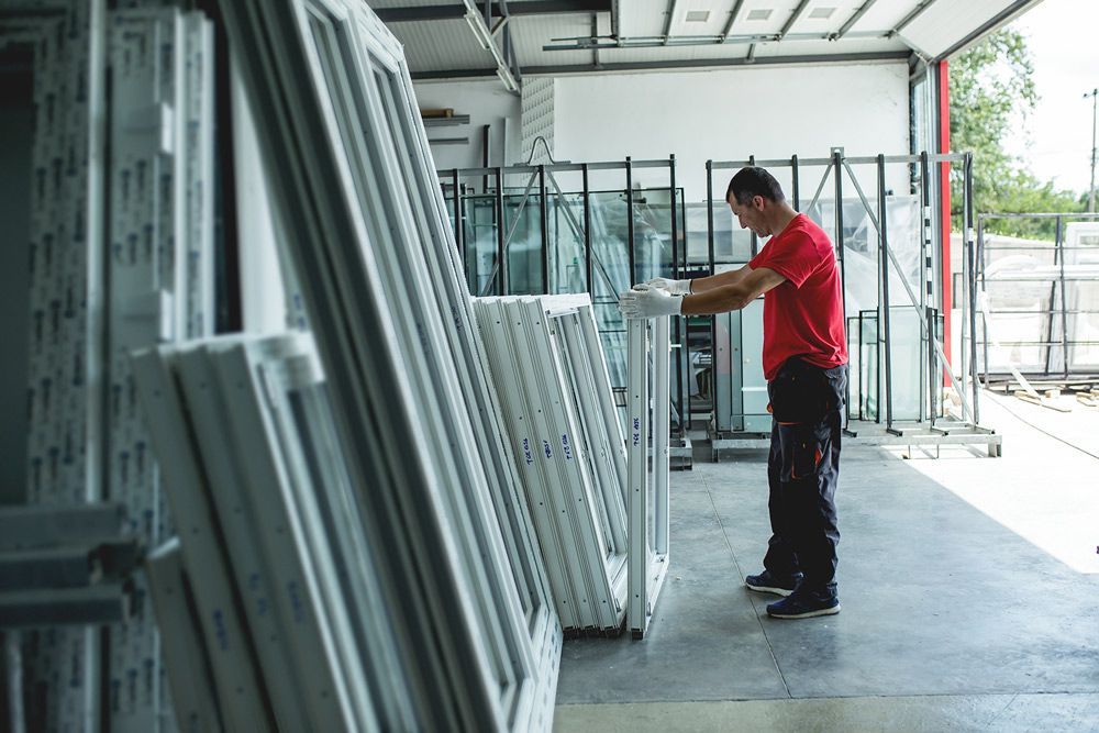 Man in Red Work Wear Checking Double Glazed Windows