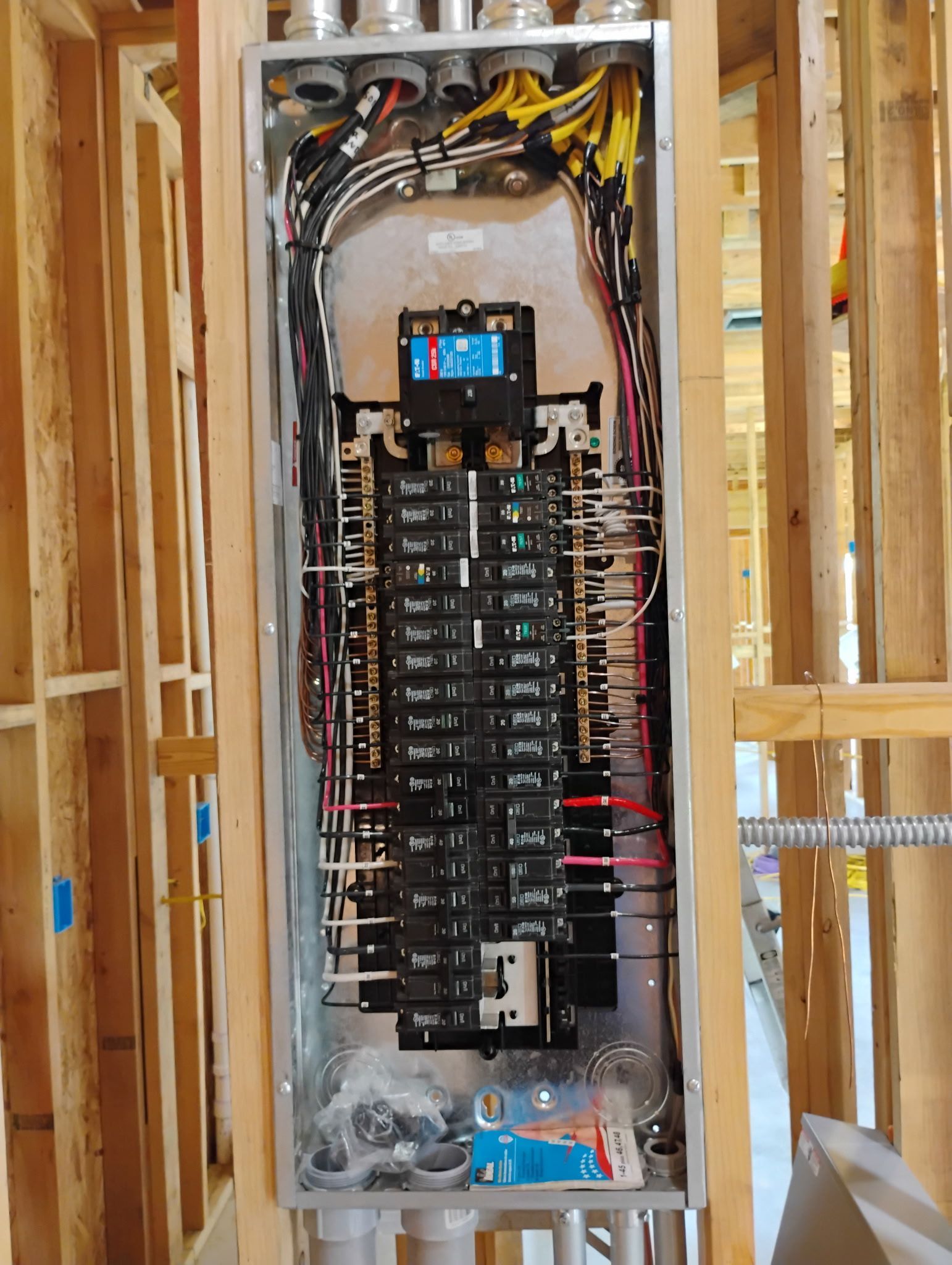 A electrical panel is being installed in a house under construction.