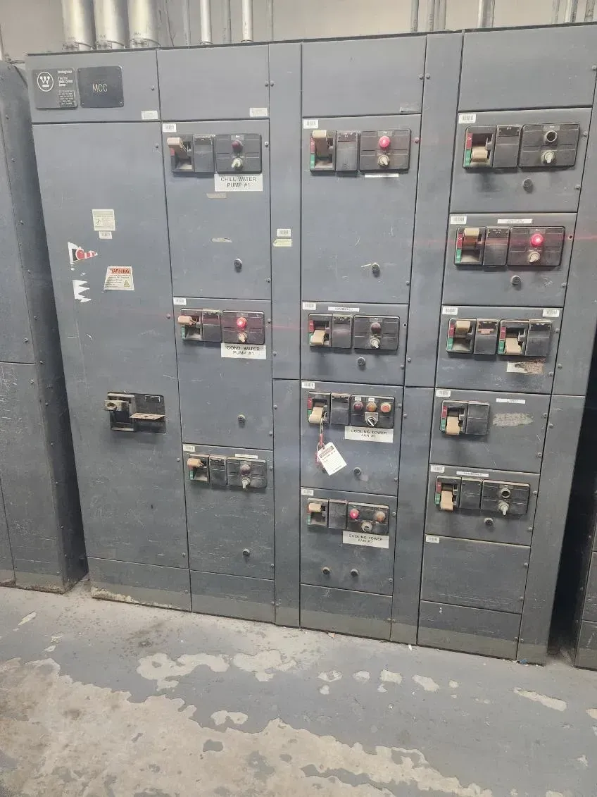 A bunch of electrical boxes are sitting next to each other in a room.