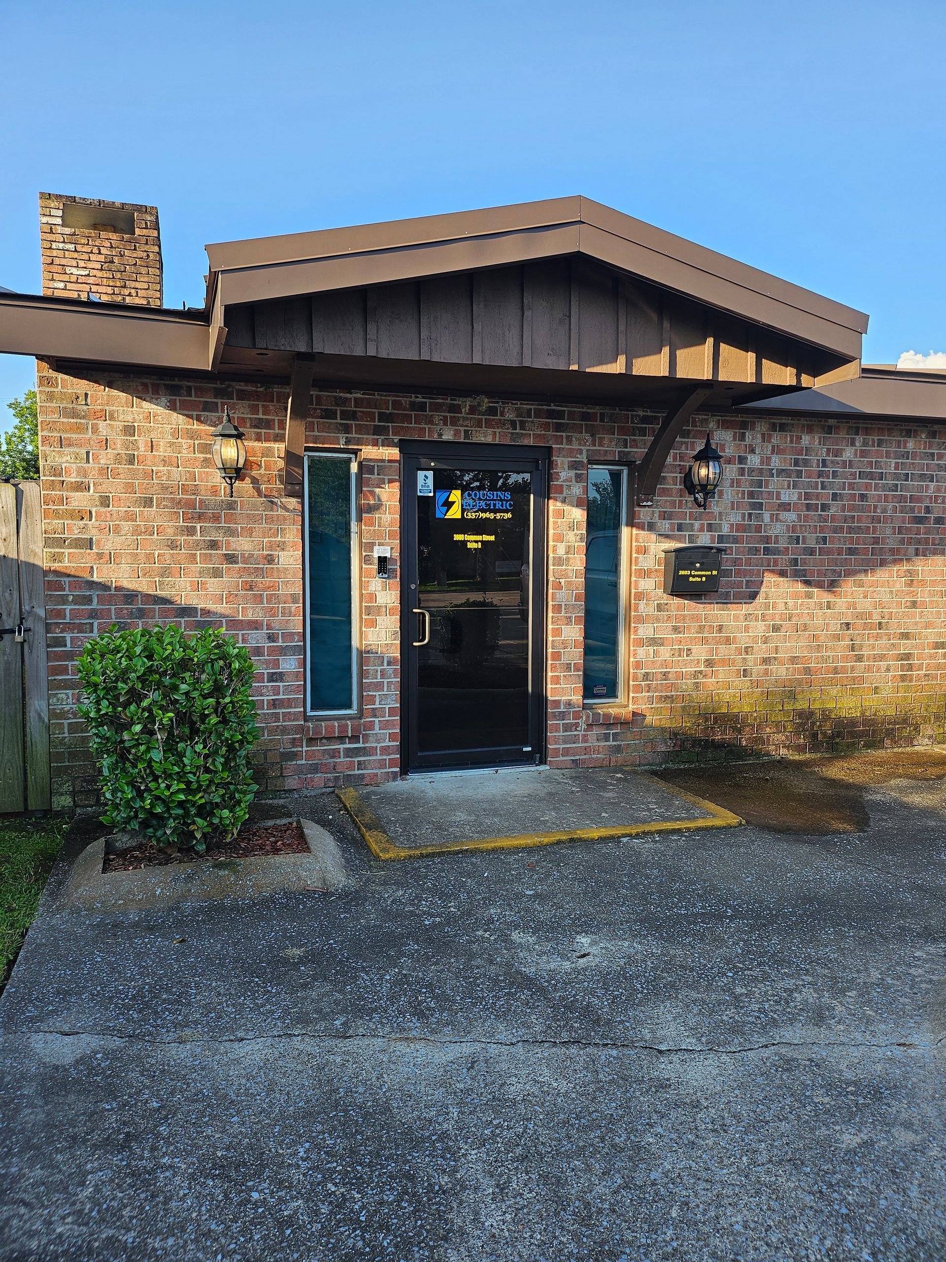 A brick building with a black door and a sign that says ' a ' on it.