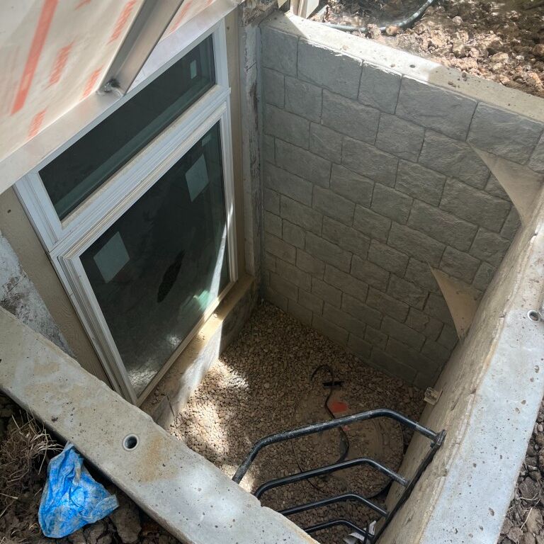 photo of concrete egress window installation
