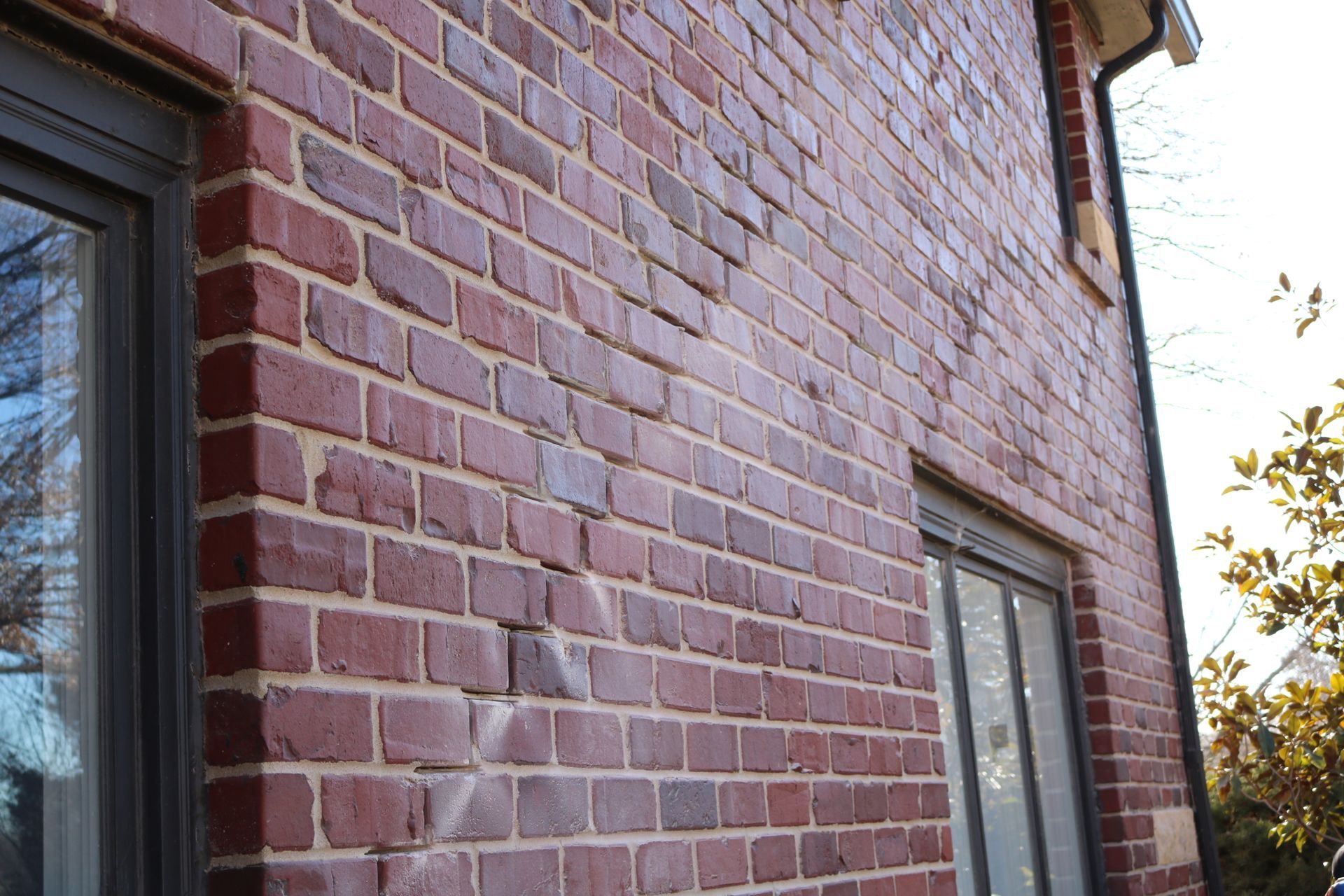 photo of cracks in mortar of brick home