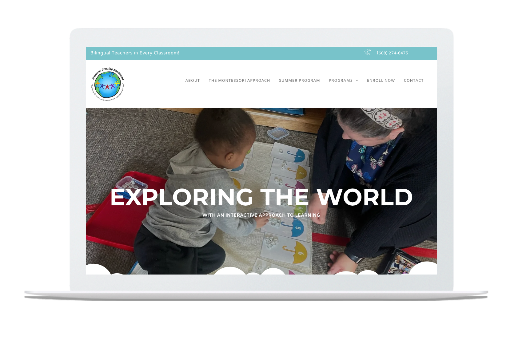A laptop screen shows a woman and a child playing with a map.