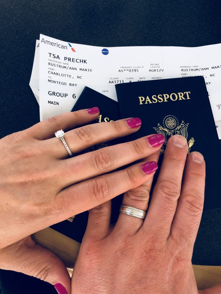 Picture of the Rustrums hands and a passport with airline ticket