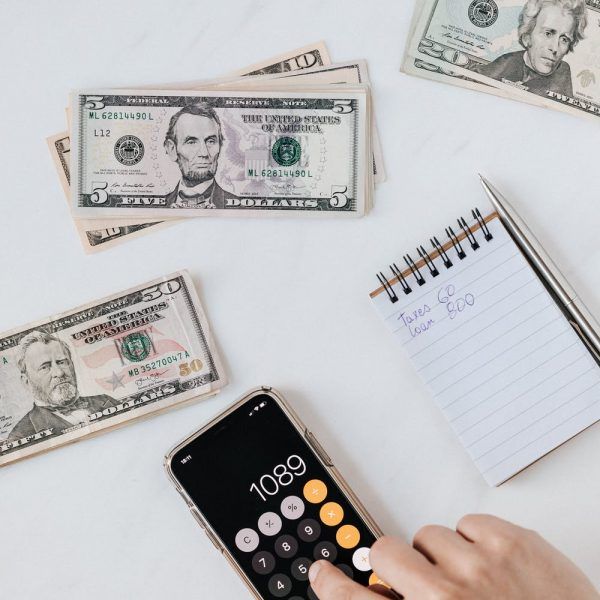 picture of cash calculator and a notepad used for blog on tips for budgeting