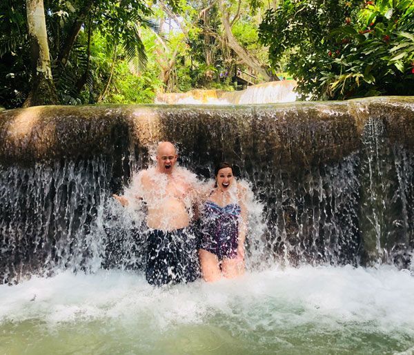 The Rustrums in a waterfall on one of their travel adventures