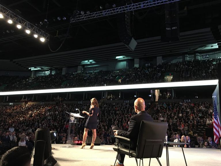 Tye Rustrum watching Ann speak on-stage