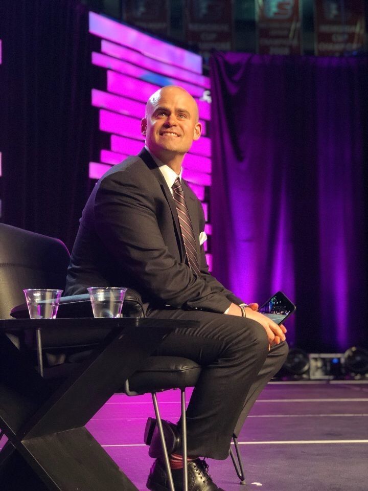 Tye on stage about to speak