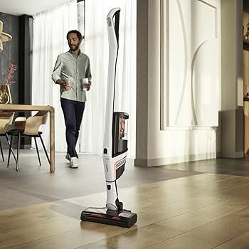 a black vacuum cleaner with a hose attached to it | Sewing Machine Repair — Orange County, California — Capistrano Vacuum & Sewing Center a black vacuum cleaner with a hose attached to it | Sewing Machine Repair — Orange County, California — Capistrano Vacuum & Sewing Center