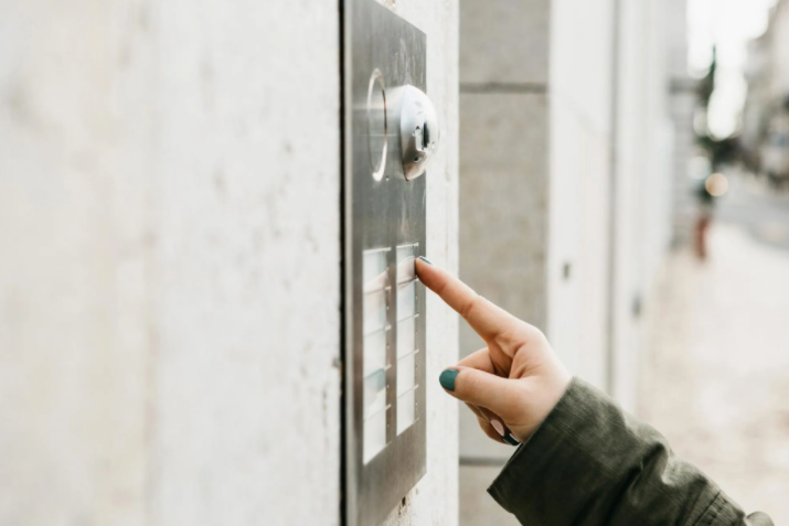 Female Hand Presses The Doorphone — Charleston, SC — Coastal Burglar Alarm