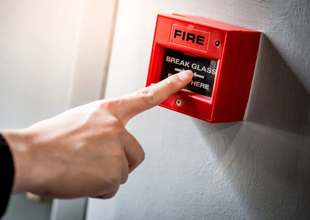 Person Pushing the Fire Alarm Switch — Charleston, SC — Coastal Burglar Alarm