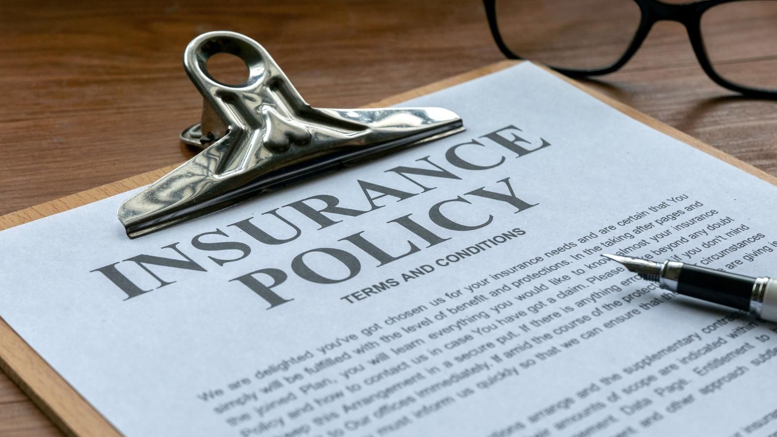 Insurance policy papers on a clipboard