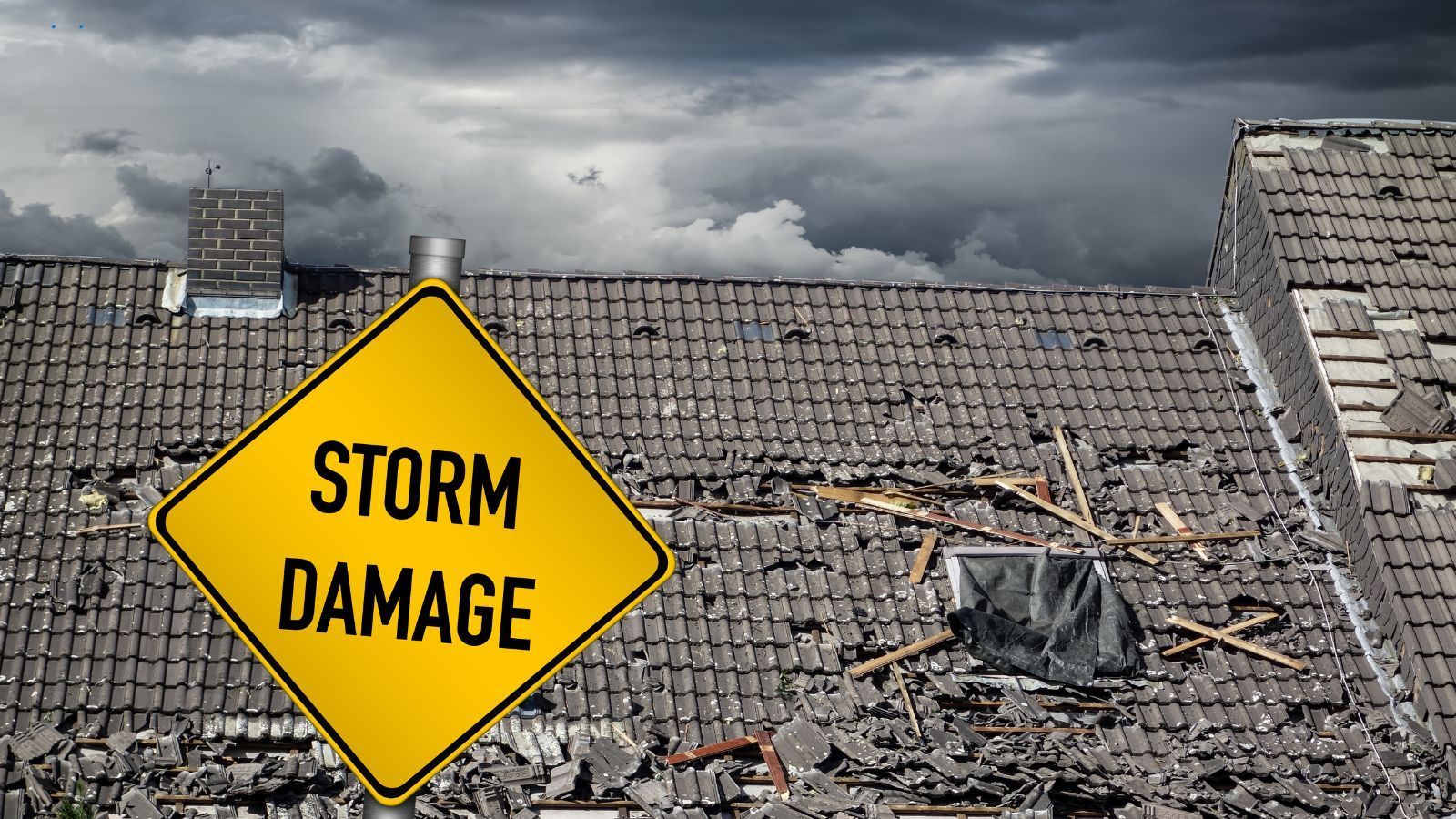 A yellow sign that says storm damage is sitting on top of a roof.