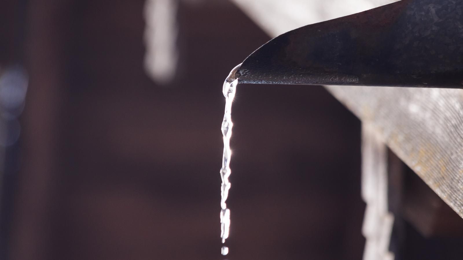 Water running neatly from a gutter.