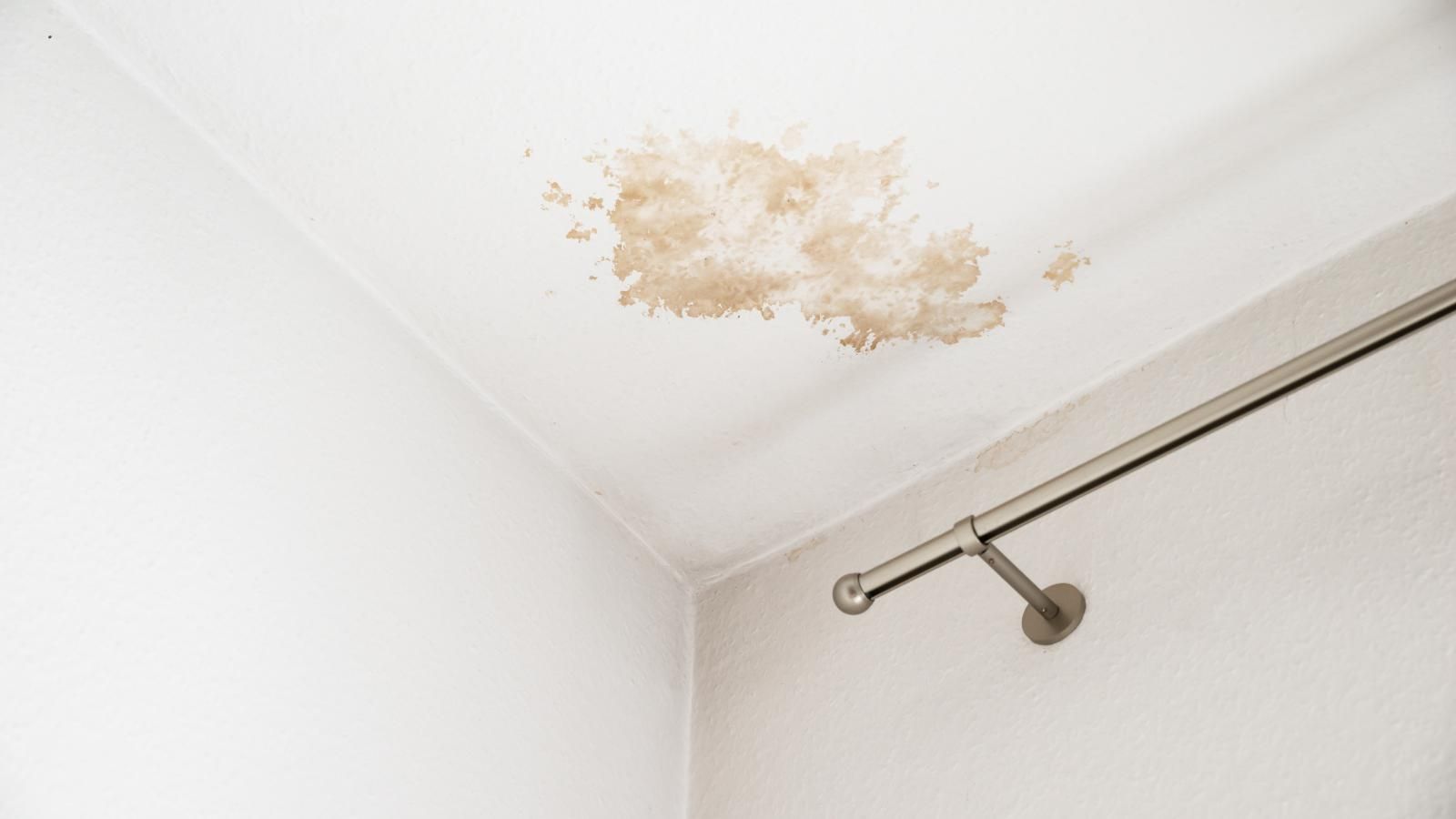 A ceiling with water damage from a roof leak.