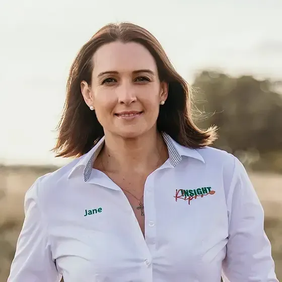 A woman wearing a white shirt with the name jane on it