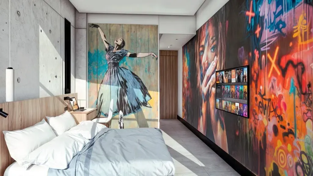 A bedroom with a large painting of a ballerina on the wall.