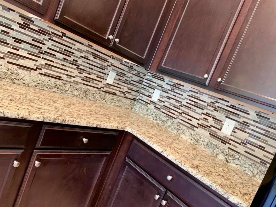A kitchen with brown cabinets and granite counter tops