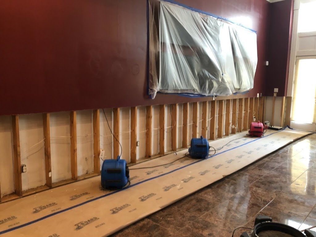 A room with a lot of wooden beams and a marble floor.