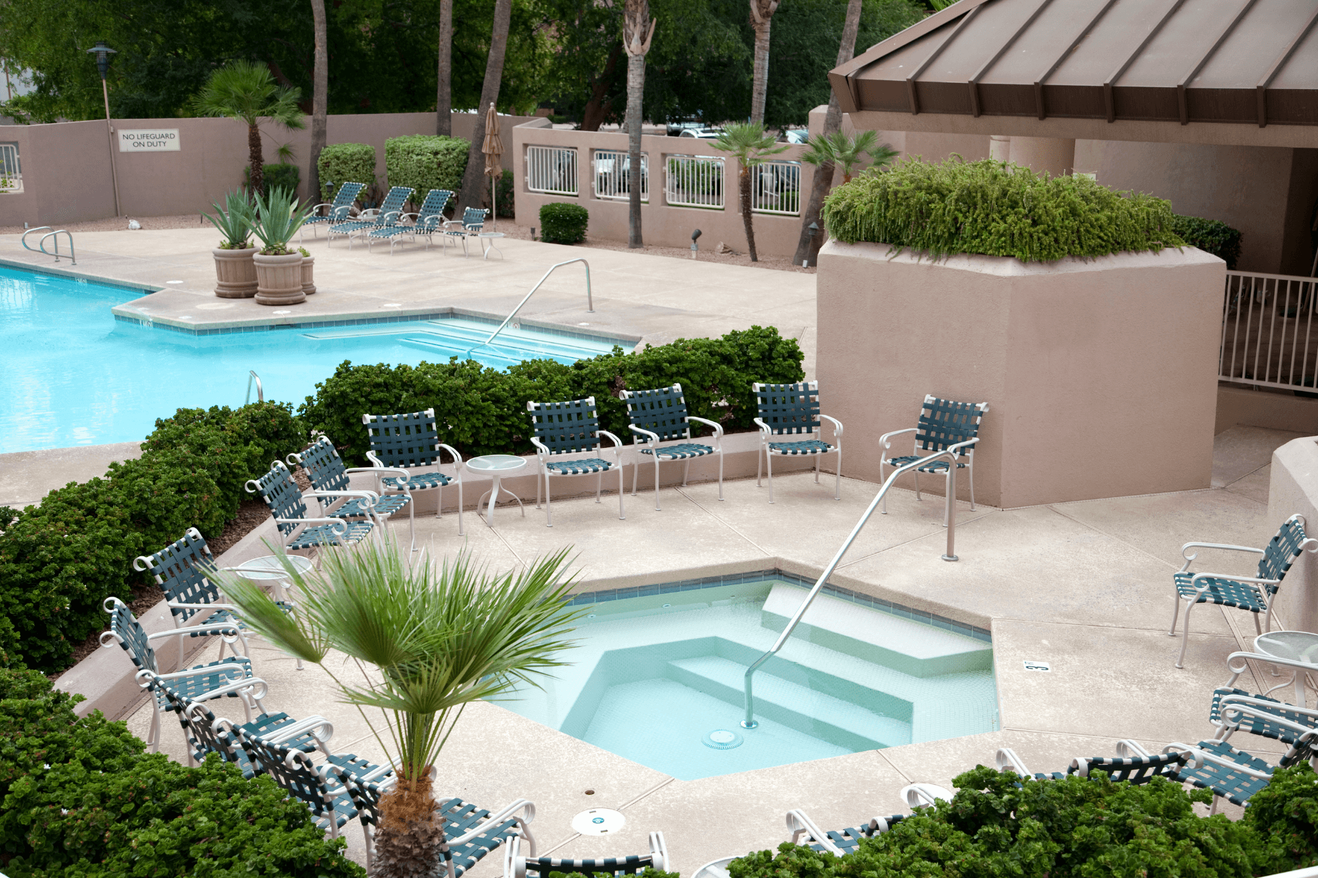 two pools with concrete pool decks