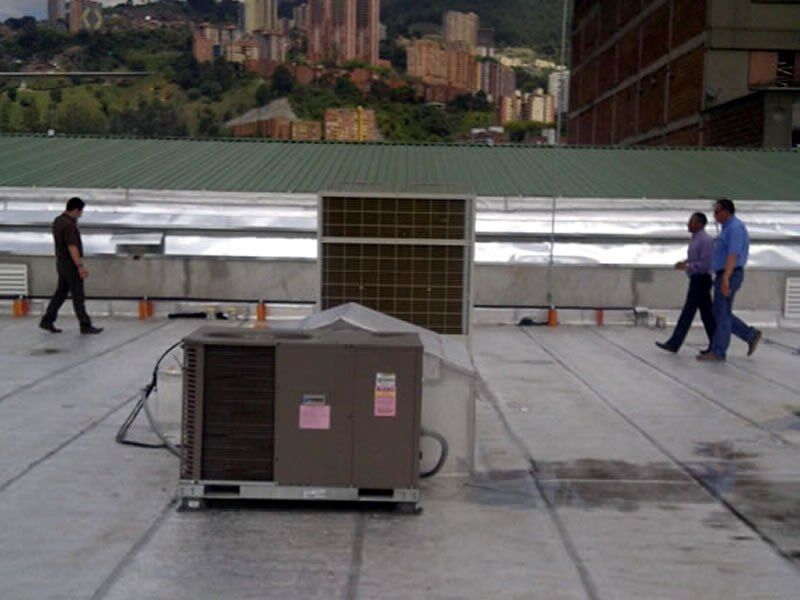 Dos hombres caminan sobre el tejado de un edificio.